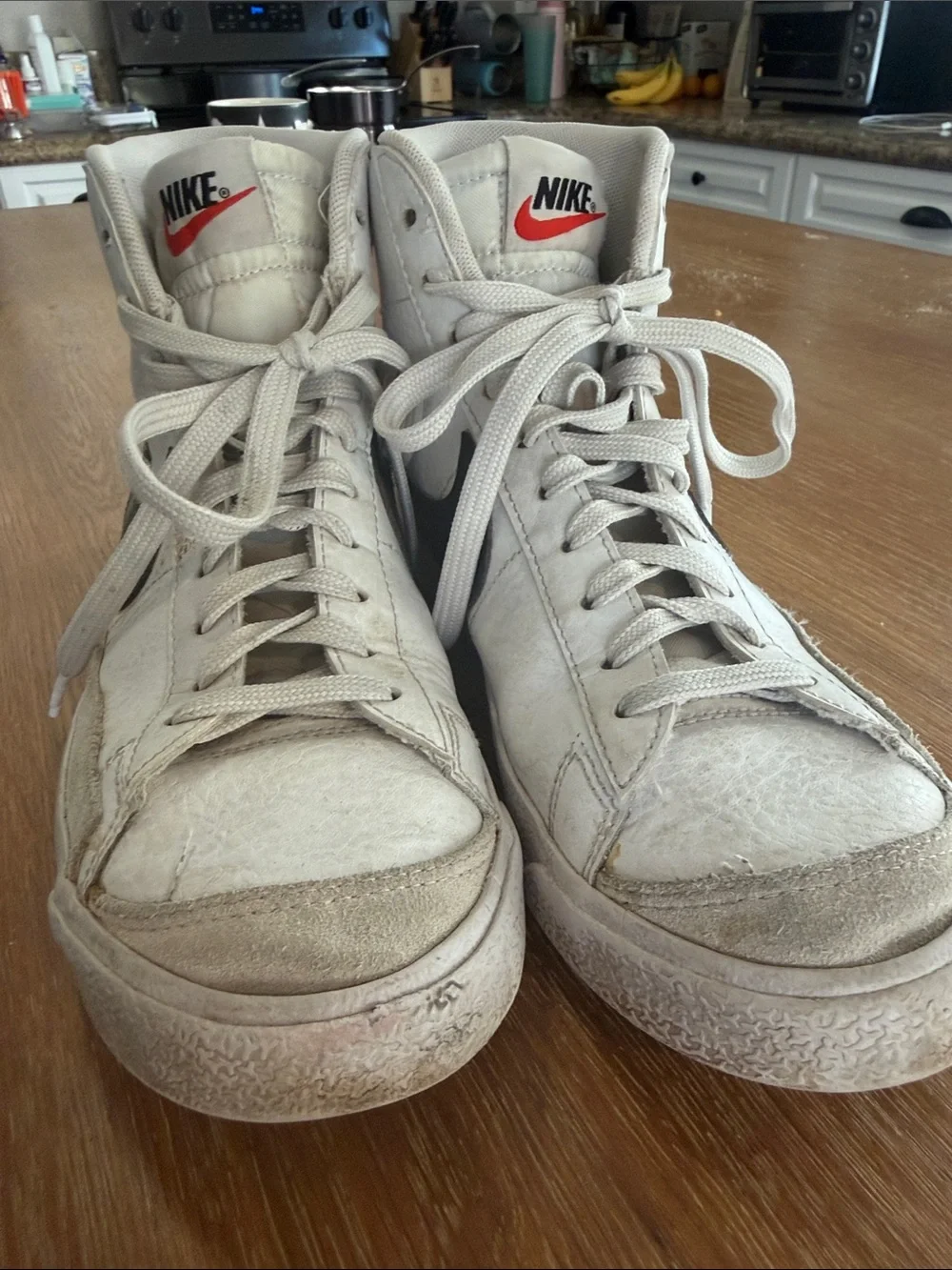 Nike White High-Top Sneakers with Black Swoosh and Red Logo